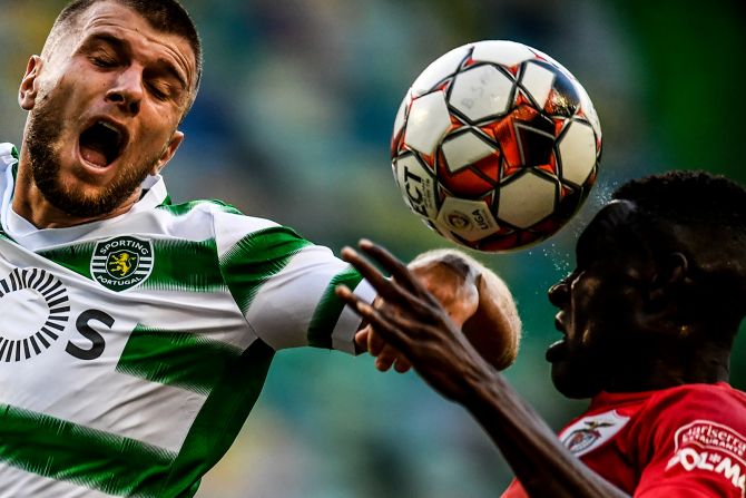 From left, Stefan Ristovski of Sporting Portugal and Santa Clara defender Zaidu Sanusi attempt to head the ball during a Portuguese League soccer match in Lisbon on July 10.