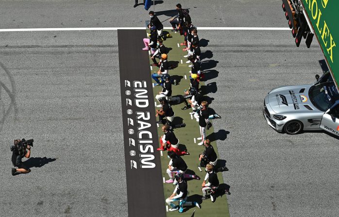 Drivers kneel behind a banner that reads "End Racism" before the Austrian Formula One Grand Prix in Spielberg, Austria, on July 5.