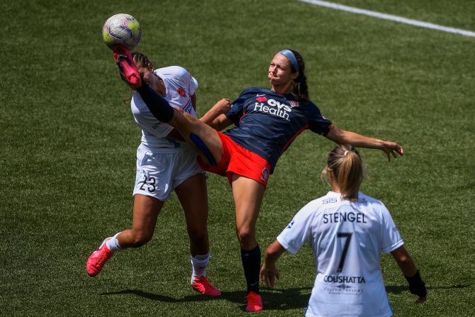 From left, Ally Prisock of the Houston Dash and Ashley Hatch of the Washington Spirit battle for a ball during an NWSL Challenge Cup match at Zions Bank Stadium in Herriman, Utah, on July 12.