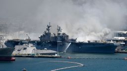 Federal firefighters continue to battle the blaze aboard the navy ship.