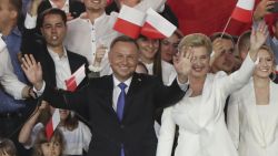 Incumbent President Andrzej Duda, left, and his wife Agata Kornhauser-Duda wave to supporters in Pultusk, Poland, Sunday, July 12, 2020. An exit poll in Poland's presidential runoff election shows a tight race that is too close to call between the conservative incumbent, Andrzej Duda, and the liberal Warsaw mayor, Rafal Trzaskowski. (AP Photo/Czarek Sokolowski)