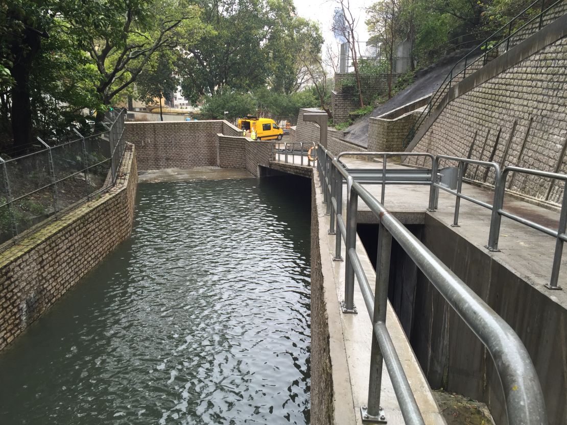 One of the tunnel's intakes, full of rainwater. The water progresses from the intake into the tunnel, instead of inundating the city below. The entrance to the tunnel lies near the middle of the photo, under the life preserver ring.