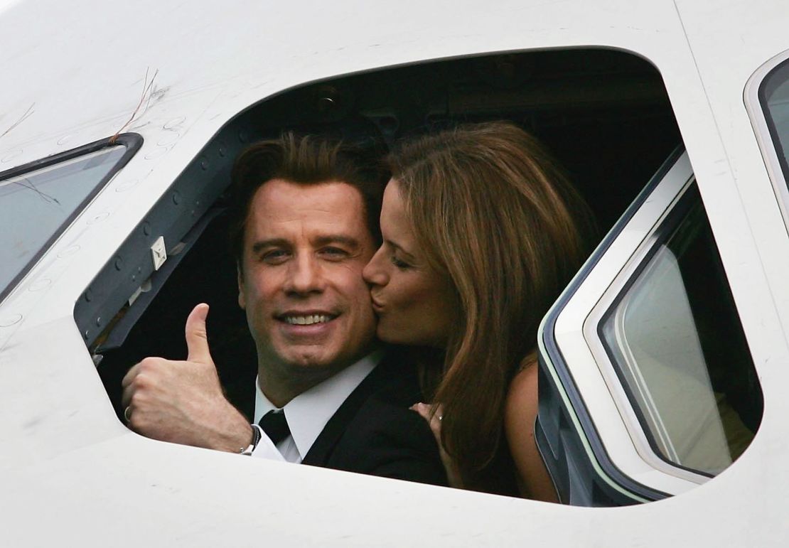 John Travolta is kissed by his wife actress Kelly Preston as they sit in the cockpit of an Airbus A380 at Brisbane International Airport on November 15, 2005.
