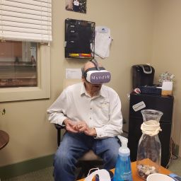 Richard Merrill using the MyndVR virtual reality system.