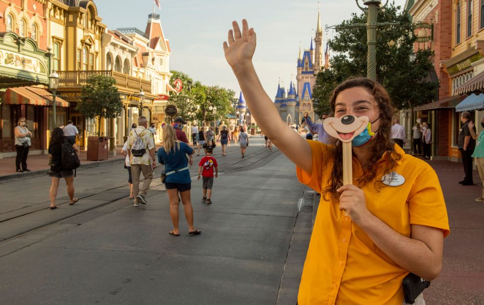 In this handout photo provided by the Walt Disney World Resort, a worker welcomes guests to the Magic Kingdom Park in Lake Buena Vista, Florida, on July 11. <a href="https://www.cnn.com/travel/article/disney-masks-covid-rides-trnd/index.html" target="_blank">The park's reopening</a> came the same weekend that Florida reached a record high for single-day case count increase.