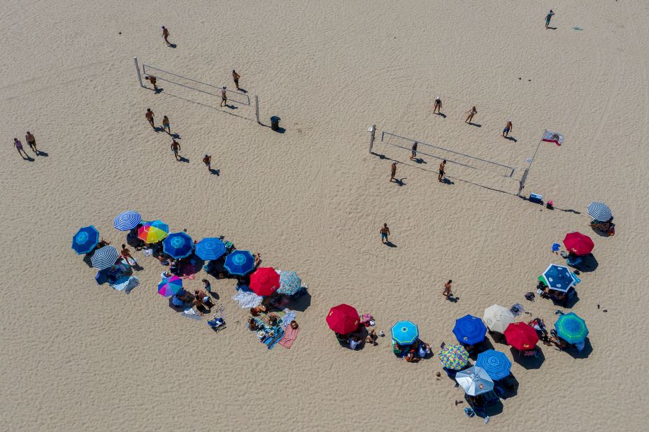 People play volleyball in Hermosa Beach, California, on July 12. Los Angeles County beaches were reopened after being closed over the Fourth of July weekend. California is one of almost three dozen states in which <a href="https://www.cnn.com/2020/07/13/us/us-coronavirus-monday/index.html" target="_blank">cases were rising.</a>