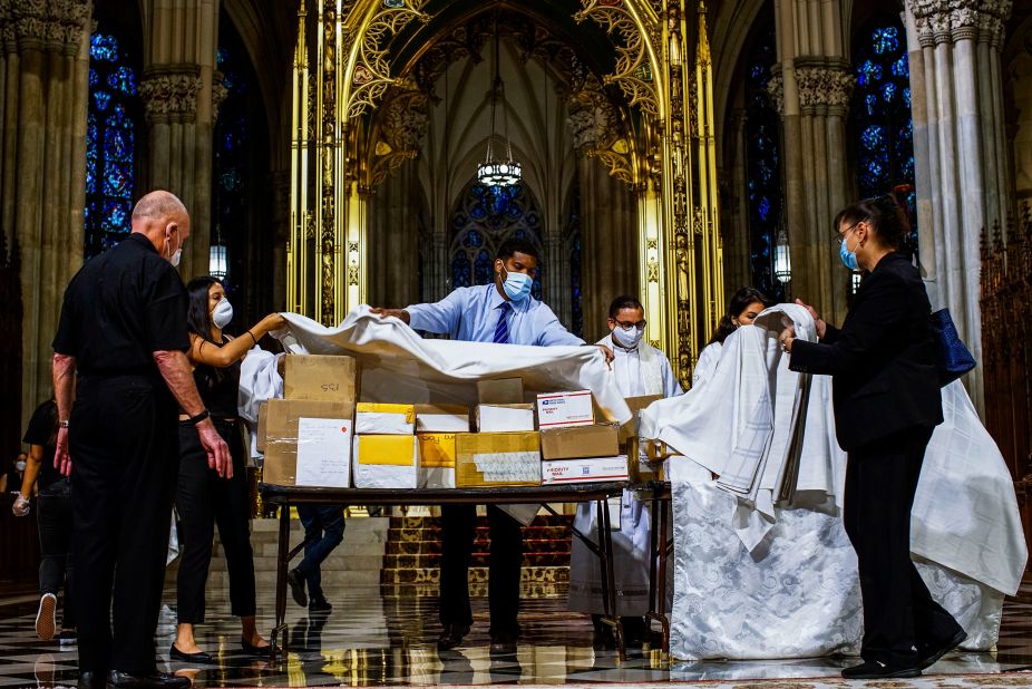 The boxed cremated remains of Mexicans who died from Covid-19 are covered before a service at  St. Patrick's Cathedral in New York on July 11. The ashes were blessed before they were repatriated to Mexico.