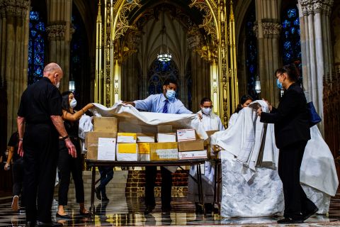 The boxed cremated remains of Mexicans who died from Covid-19 are covered before a service at  St. Patrick's Cathedral in New York on July 11. The ashes were blessed before they were repatriated to Mexico.