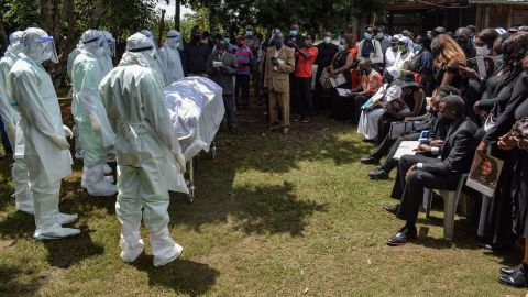 Members of the Bungoma County Isolation Team stand by the coffin of Dr. Doreen Lugaliki during her funeral in Ndalu, Kenya, on July 13. Lugaliki, 39, died from complications related to the novel coronavirus.