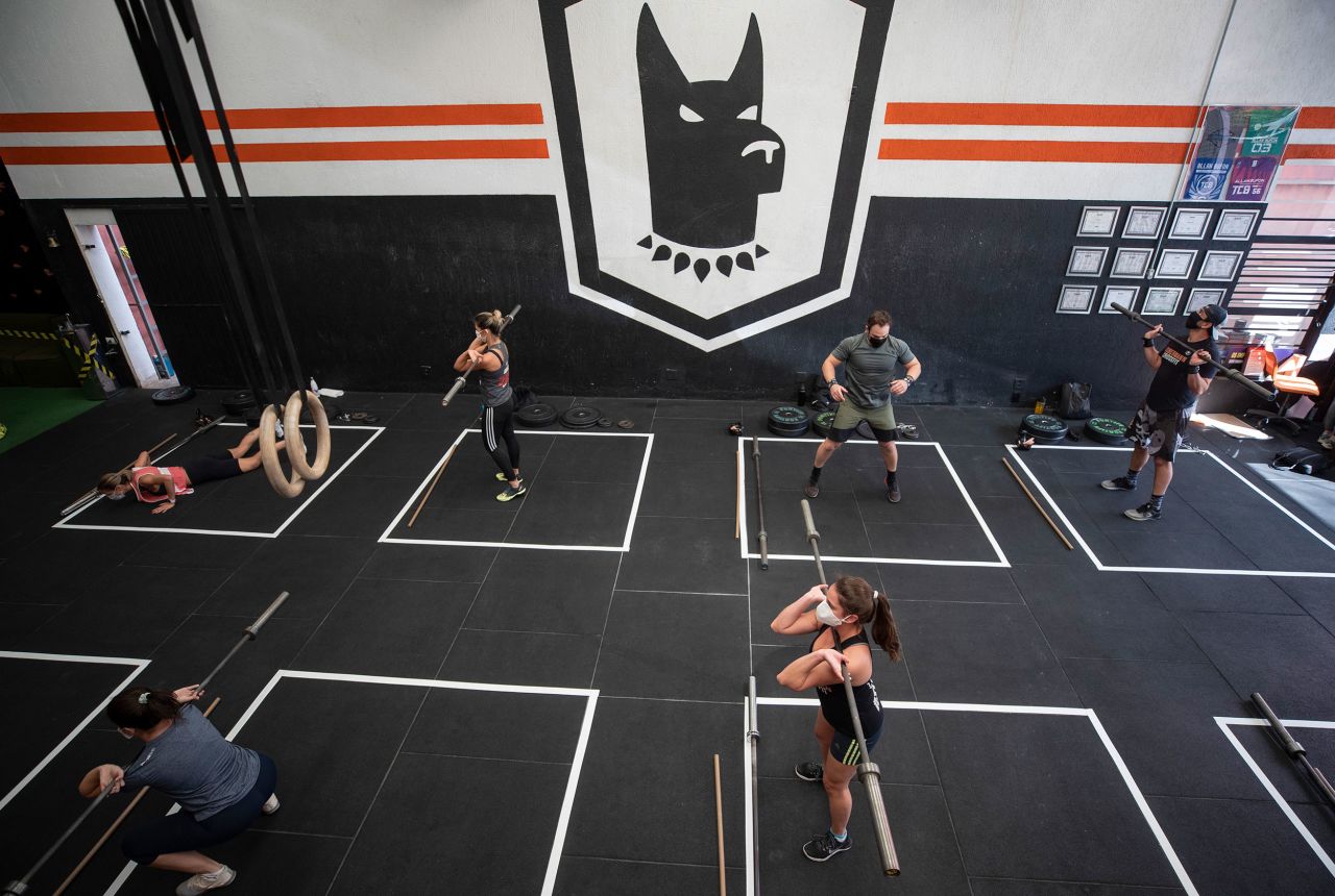 A floor is marked for social distancing as people exercise inside a gym in Sao Paulo, Brazil, on July 13. Gyms were allowed to reopen after more than three months of lockdown.