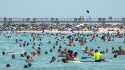 Mandatory Credit: Photo by CRISTOBAL HERRERA/EPA-EFE/Shutterstock (10709557d)People enjoy a warm day at the beach in Miami Beach, Florida, USA, 12 July 2020. Florida reports 15,300 new Coronavirus cases, a record for one day anywhere in the US.Coronavirus in Miami, USA - 12 Jul 2020