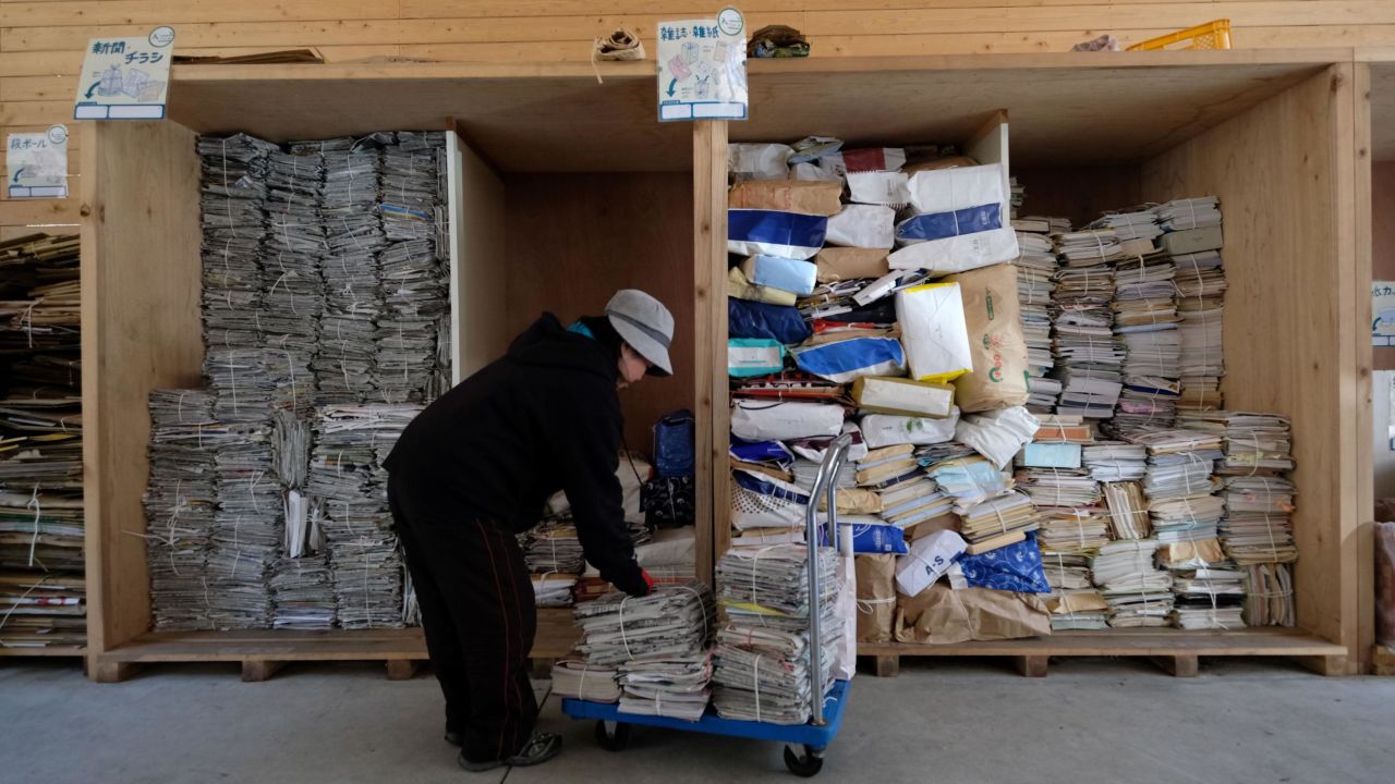 A worker sorts newspapers and magazines for recycling at a waste center in Kamikatsu.