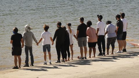 Friends and former castmates held hands and shouted "Say her name -- Naya," as they gathered at Lake Piru on Monday morning.