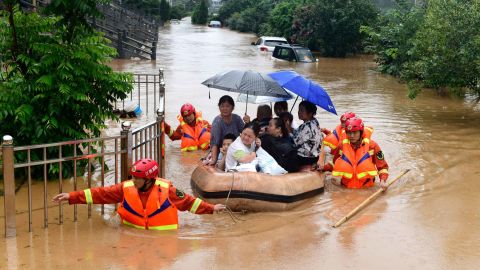 Rescuers evacuate residents on a raft through flood waters in Jiujiang in central China's Jiangxi province on July 8.