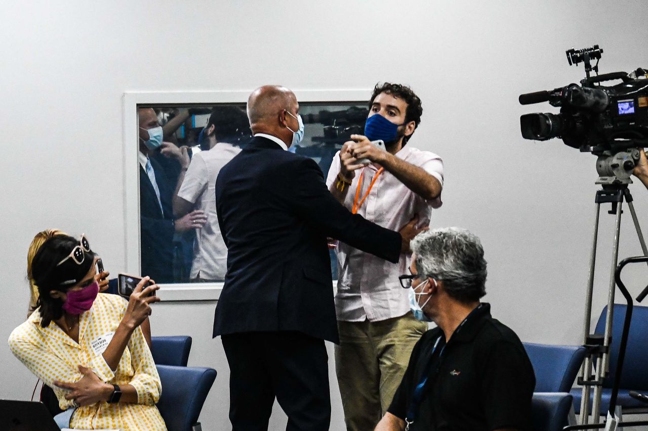Activist Thomas Kennedy is escorted away by security as he <a href="https://edition.cnn.com/videos/politics/2020/07/14/desantis-heckler-coronavirus-press-conference-flores-sot-newday-vpx.cnn" target="_blank">heckles Florida Gov. Ron DeSantis</a> during a briefing in Miami on July 13. <a href="https://www.cnn.com/2020/07/13/health/florida-coronavirus-cases-comparisons/index.html" target="_blank">If Florida were a country,</a> it would have ranked No. 9 in the number of Covid-19 cases worldwide, according to Johns Hopkins data that day.