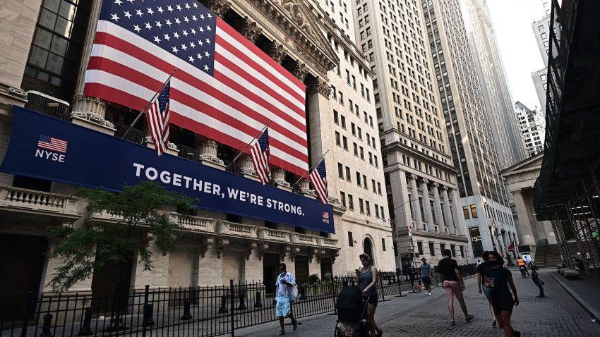 People walk outside the New York Stock Exchange (NYSE) on July 13, 2020 at Wall Street in New York City. - The Nasdaq tumbled July 13, 2020, ending a three-session streak of records on a weak day for US stocks amid fresh restrictions in California to address the coronavirus. (Photo by Johannes Eisele/AFP/Getty Images)