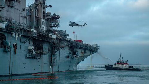 A MH-60S Sea Hawk helicopter prepares to drop water on the USS Bonhomme Richard.