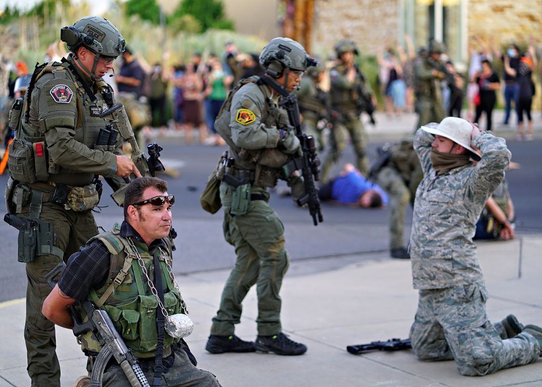 Albuquerque police detain members of the New Mexico Civil Guard last month in Albuquerque.