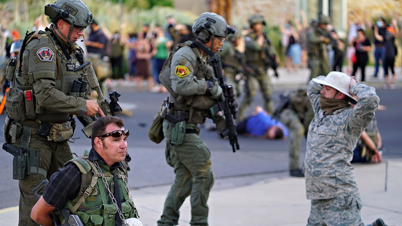 Albuquerque police detain members of the New Mexico Civil Guard last month in Albuquerque.