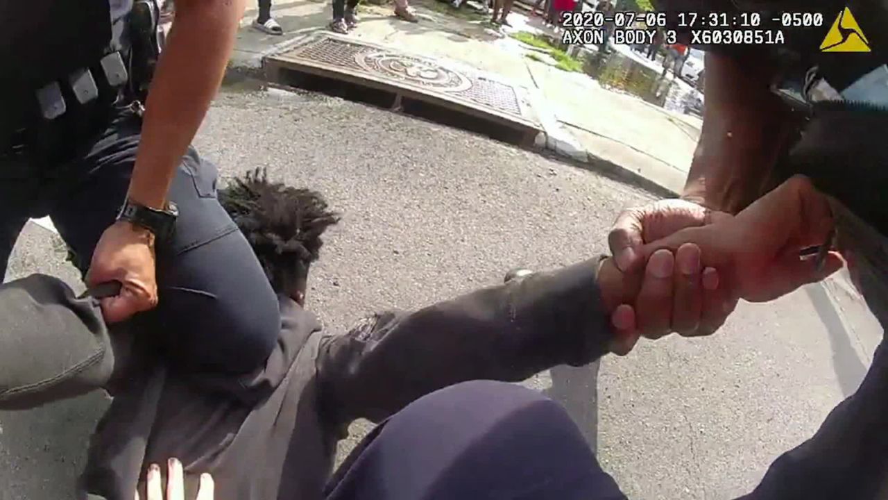 An officer uses his knee to restrain a 17-year-old suspect who was a passenger in a 54-minute car chase on July 6.