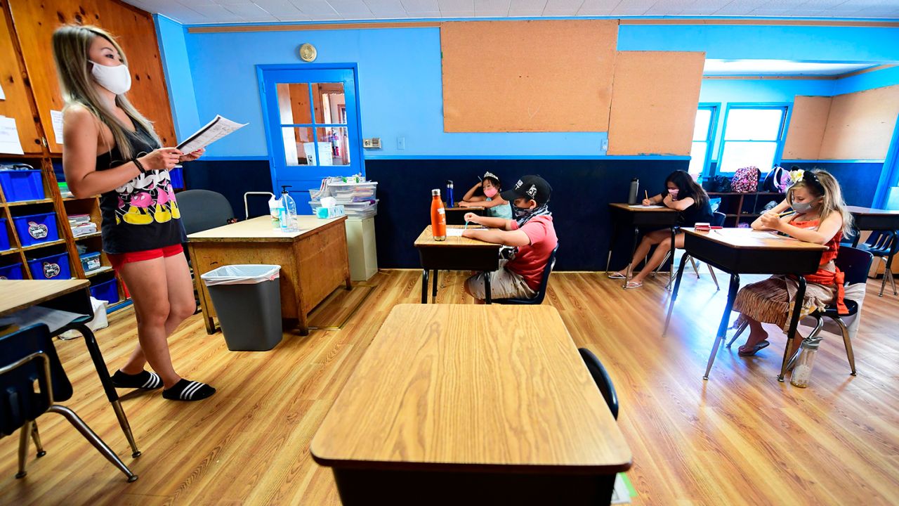 Instructor Amy Giang teaches a class of 4th-7th graders, wearing masks and spaced apart as per coronavirus guidelines, during summer school sessions at Happy Day School in Monterey Park, California on July 9, 2020. - California Governor Gavin Newsom says the reopening of California schools for the coming school year will be based on safety and not pressure from President Donald Trump as California sets records for one-day increases in COVID-19 cases. (Photo by Frederic J. BROWN / AFP) (Photo by FREDERIC J. BROWN/AFP via Getty Images)