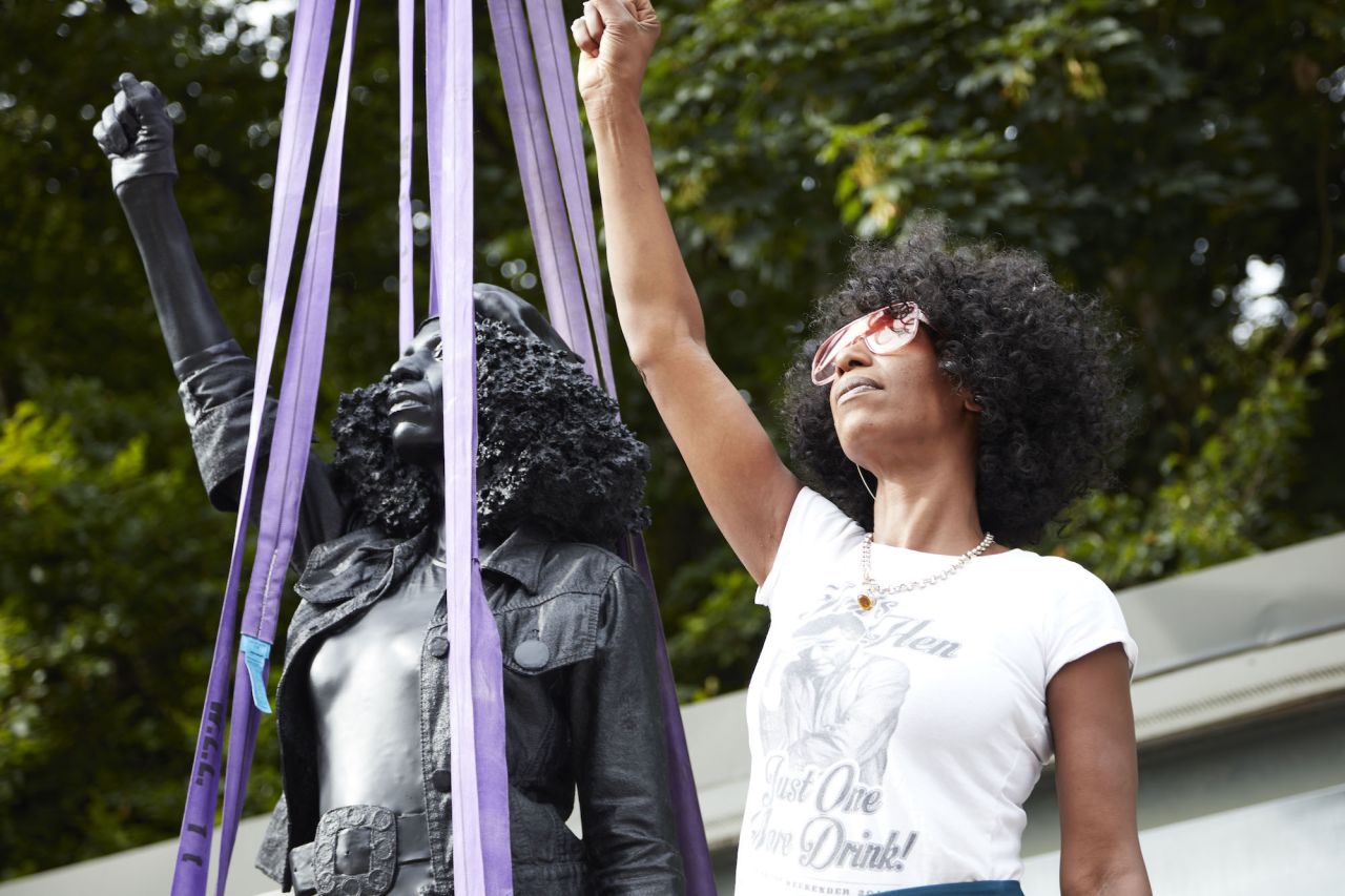Jen Reid pictured alongside the statue.