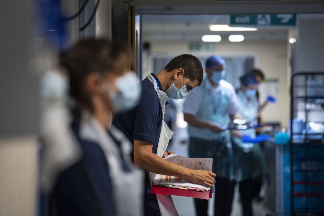 A rehab support worker checks on patient notes as the first patients are admitted to the the NHS Seacole Centre at Headley Court, Surrey on May 28, 2020.