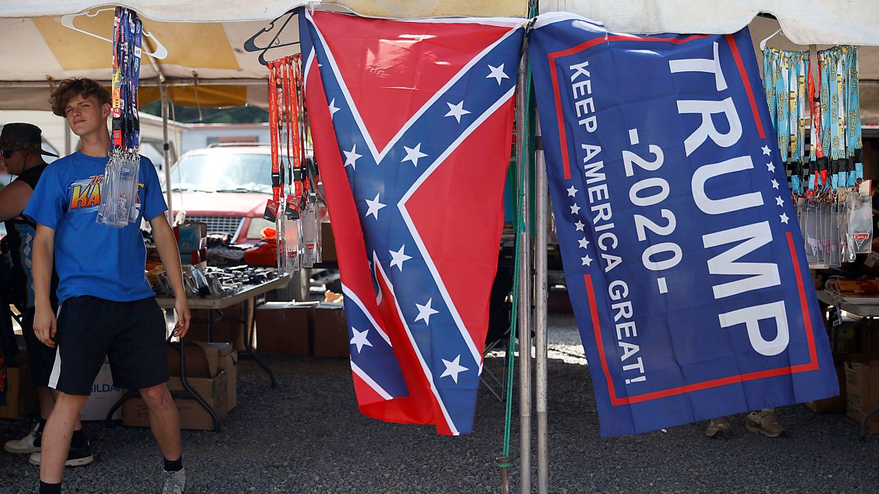 A vendor displays a Confederate flag and Trump 2020 flag outside of the Bristol Motor Speedway prior to the race.