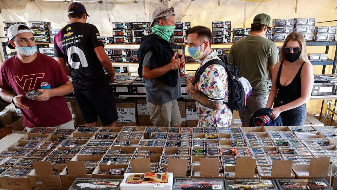 Fans wearing face masks shop for memorabilia.