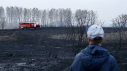 NOVOSIBIRSK REGION, RUSSIA - APRIL 23, 2020: A man looks at a fire engine near a dacha community in Moshkovo District, Novosibirsk Region, south Siberia, during a fire. Novosibirsk Region is experiencing hundreds of fires believed to have been caused by burning old grass. Kirill Kukhmar/TASS (Photo by Kirill Kukhmar\TASS via Getty Images)