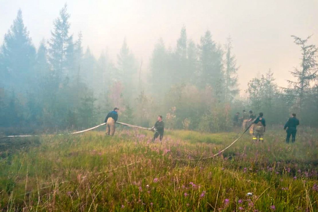 Firefighters battle to extinguish forest fires near the village of Batagay, Sakha Republic in northeastern Russia.