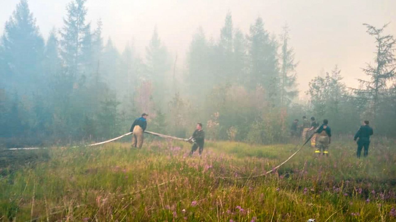 Firefighters battle to extinguish forest fires near the village of Batagay, Sakha Republic in northeastern Russia.