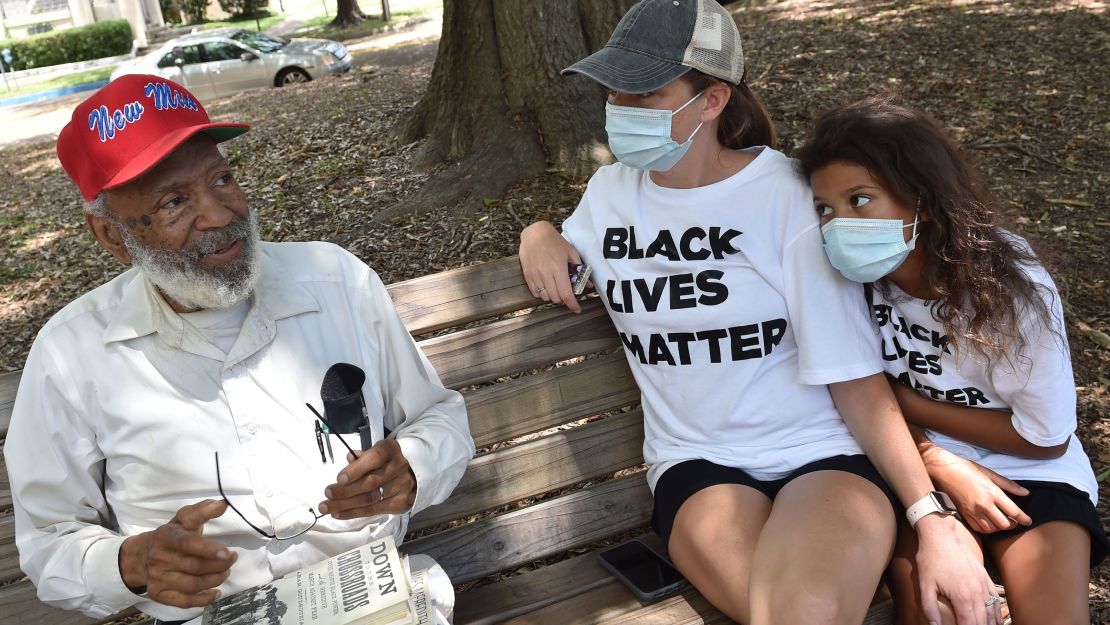 James Meredith sits on a park bench in Jackson with Keri Herrington and Eriyuanna Woods last month.