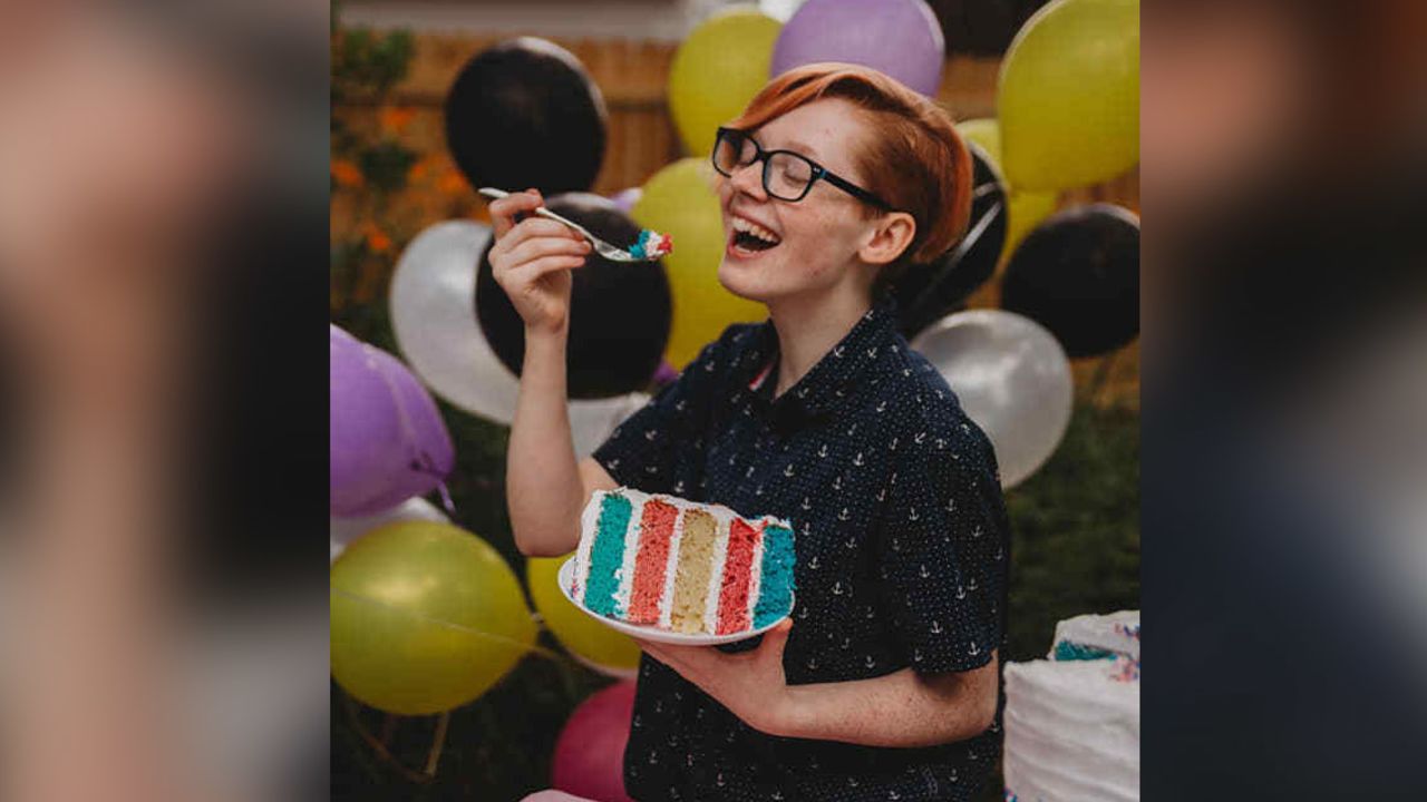 Schoolcraft enjoying his cake that was layered with the colors of the transgender pride flag.