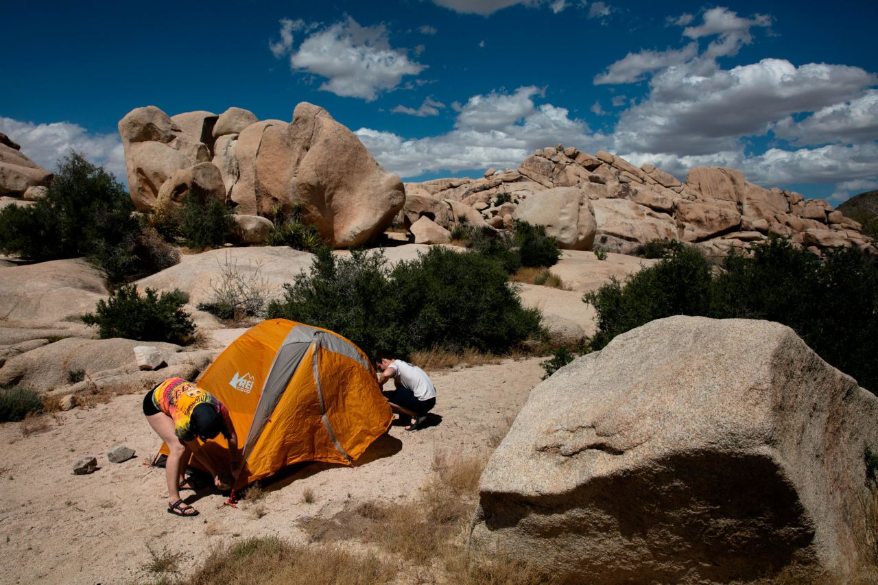 Marta Jerebets, left, and Arthur Pettit pitch their tent on a campground at Joshua Tree National Park in California on May 19, 2020.