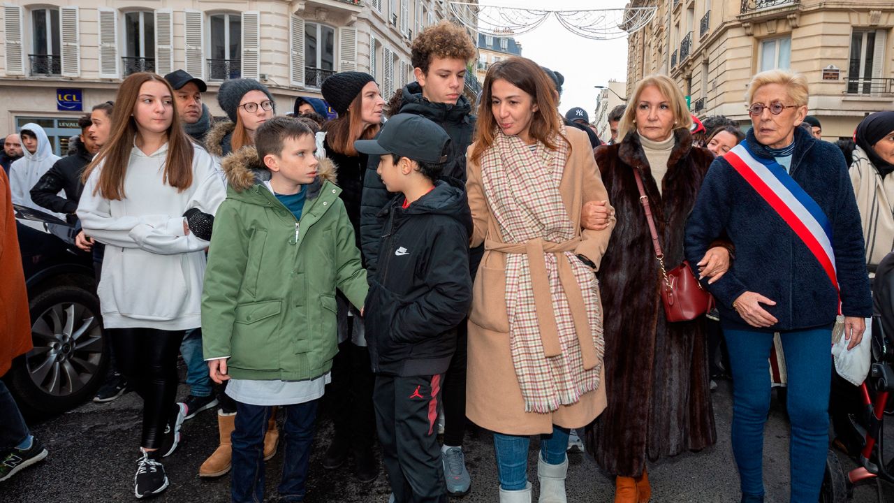 Cedric Chouviat's widow Doria and her children take part in a march in Levallois, near Paris, on January 12, 2020.