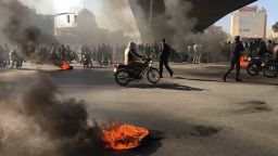Iranian protesters rally amid burning tires during a demonstration against an increase in gasoline prices, in the central city of Isfahan on November 16, 2019. - One person was killed and others injured in protests across Iran, hours after a surprise decision to increase petrol prices by 50 percent for the first 60 litres and 300 percent for anything above that each month, and impose rationing. Authorities said the move was aimed at helping needy citizens, and expected to generate 300 trillion rials ($2.55 billion) per annum. (Photo by - / AFP) (Photo by -/AFP via Getty Images)
