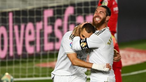 Karim Benzema celebrates with Sergio Ramos after scoring his second.