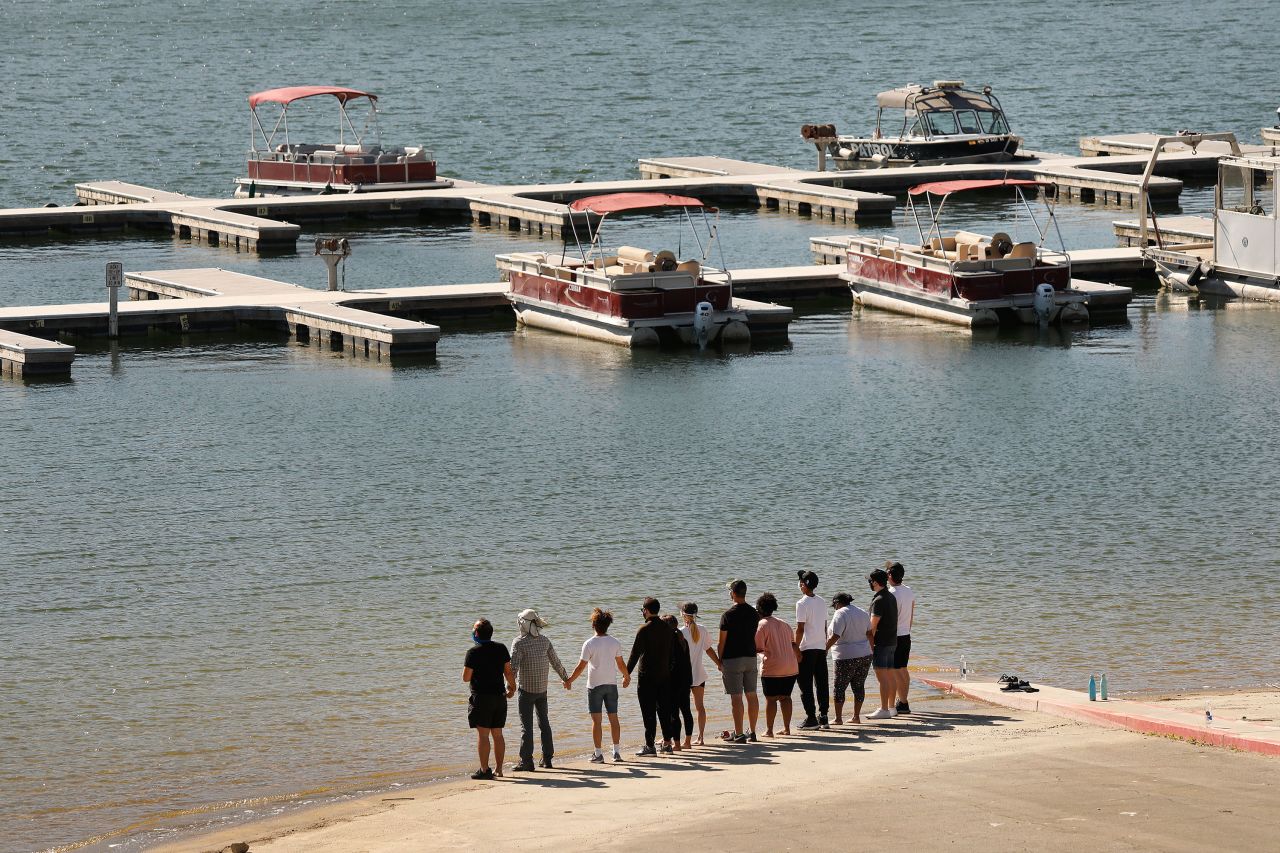 Cast members from the TV show "Glee" hold hands with friends and shout "Say her name: Naya" at Southern California's Lake Piru on Monday, July 13. The body of former "Glee" actress Naya Rivera <a href="https://www.cnn.com/2020/07/13/entertainment/naya-rivera-search-body-found/index.html" target="_blank">was found in the lake that morning,</a> the Ventura County Sheriff's Office said. Rivera, 33, had been presumed dead after she went missing on July 8. She had gone to the lake and rented a pontoon boat with her 4-year-old son, according to authorities. Rivera's son was later seen on the boat, but his mother was nowhere to be found.