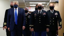 President Donald Trump wears a face mask as he walks down a hallway during a visit to Walter Reed National Military Medical Center in Bethesda, Md., Saturday, July 11, 2020. 
