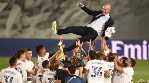 Real Madrid players celebrate with head coach Zinedine Zidane.