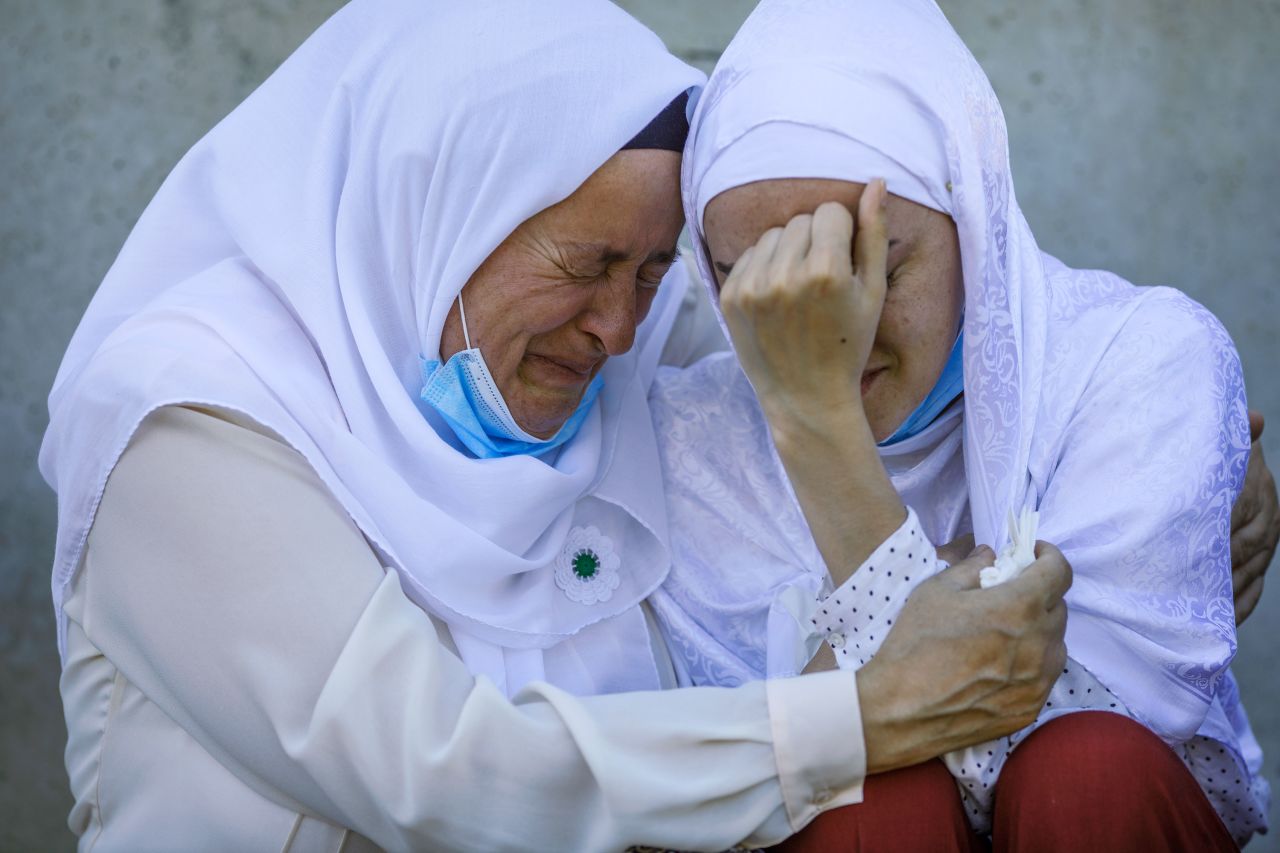 A woman in Potocari, Bosnia and Herzegovina, is hugged by her mother after seeing a coffin with the remains of her father, a victim of <a href="https://www.cnn.com/2015/07/11/europe/srebrenica-massacre-bosnians/" target="_blank">the 1995 Srebrenica massacre,</a> on Friday, July 10.