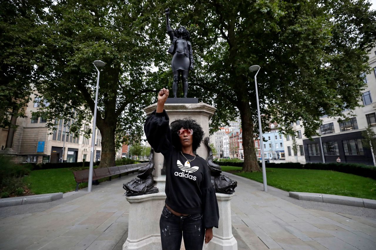 Black Lives Matter protester Jen Reid poses in front of a statue portraying her in Bristol, England, on Wednesday, July 15. The statue, by artist Marc Quinn, was secretly installed overnight where a monument to a slave trader had previously stood. The statue of Reid lasted one day before <a href="https://www.cnn.com/style/article/black-lives-matter-bristol-statue-removed-scli-gbr-intl/index.html" target="_blank">it was taken down and moved to a museum.</a>