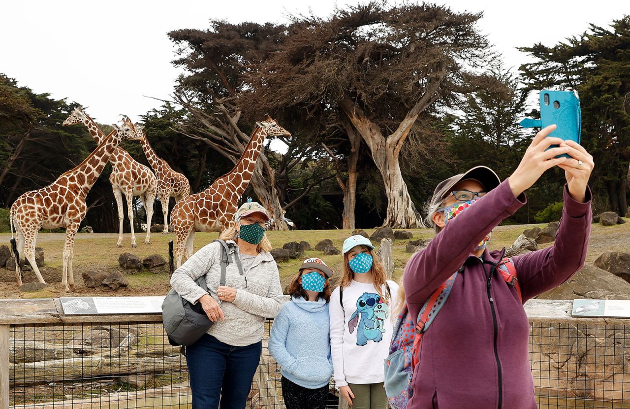 A family takes a selfie with giraffes as the San Francisco Zoo reopened for members on Monday, July 13.