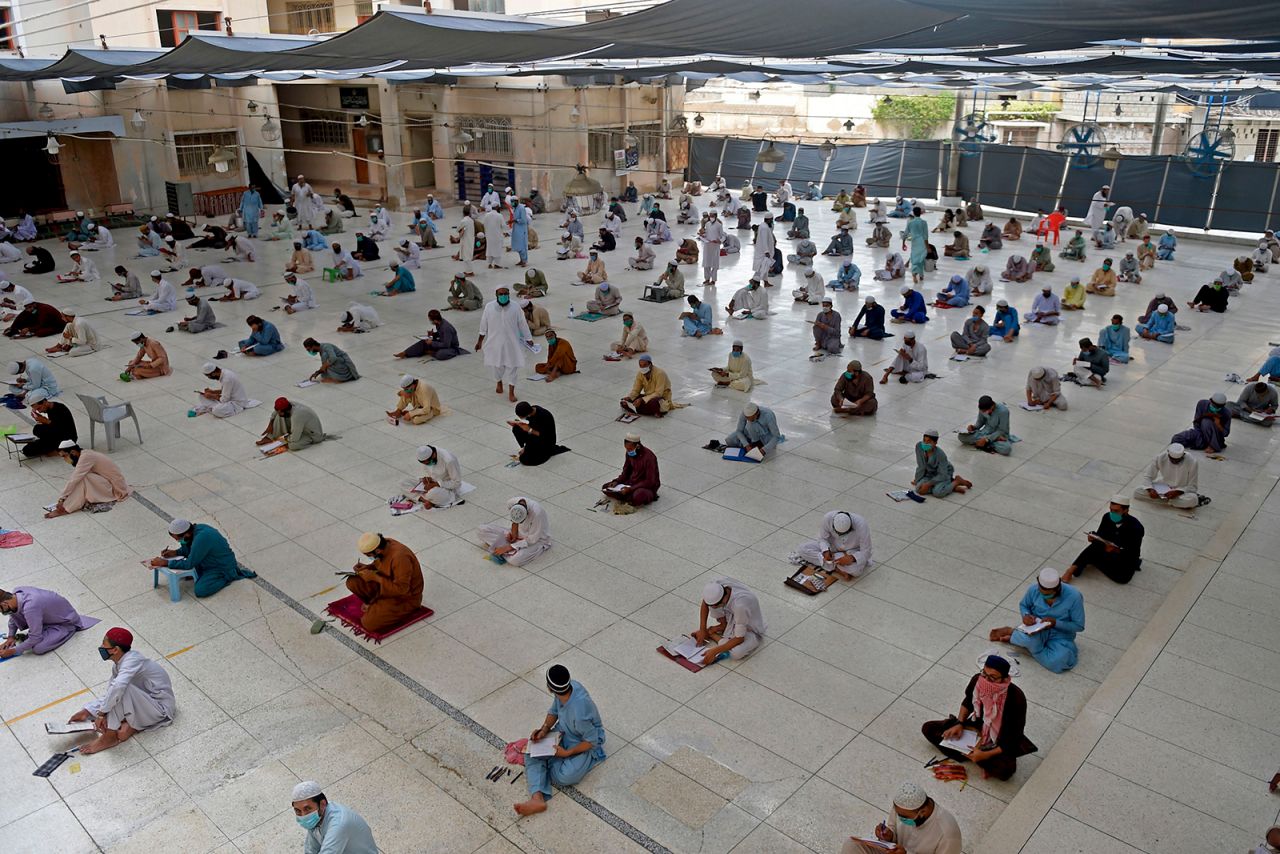 Students attend their final exam at an Islamic seminary in Karachi, Pakistan, on Monday, July 13.