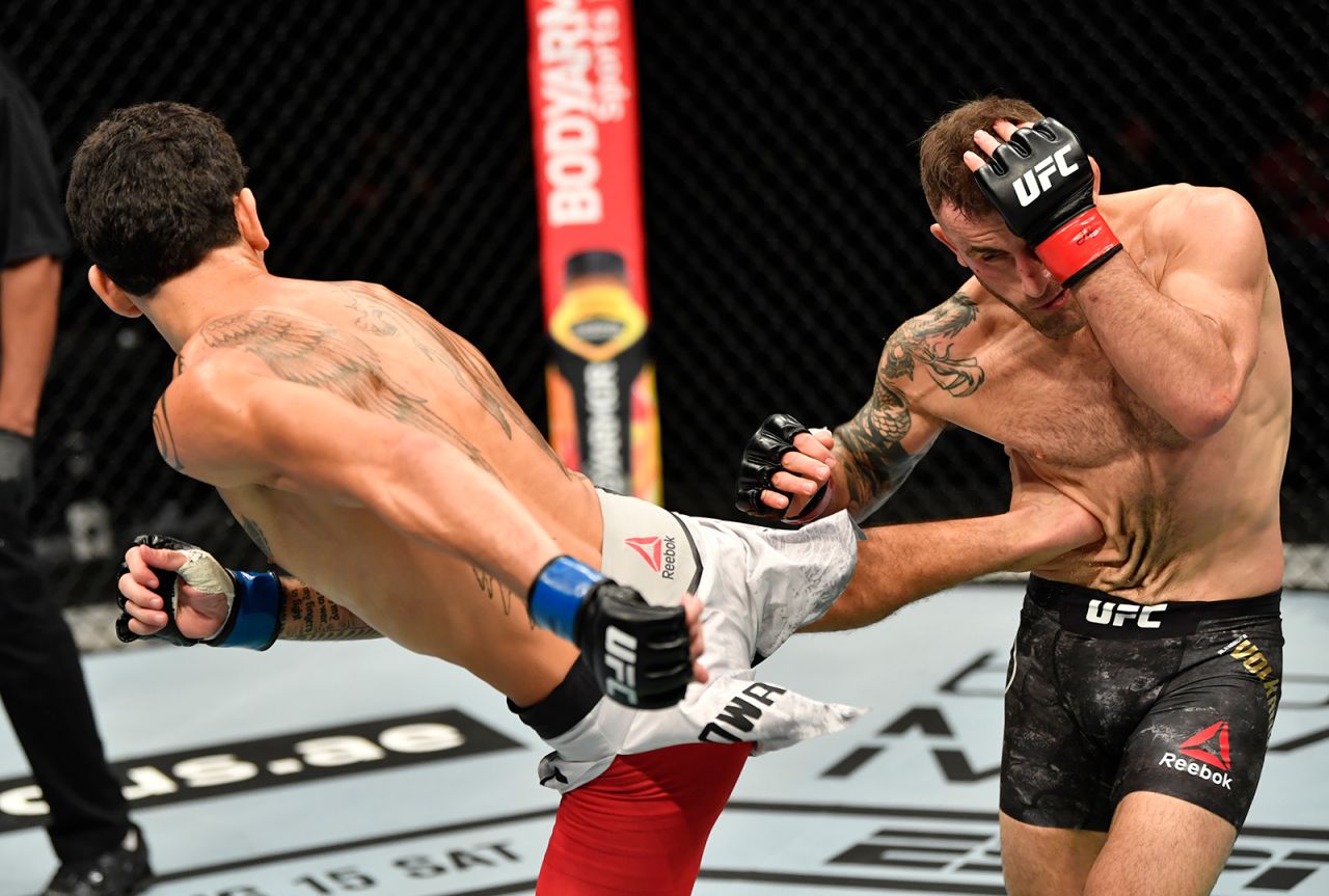 Max Holloway kicks Alexander Volkanovski during their UFC bout in Abu Dhabi, United Arab Emirates, on Saturday, July 12. Volkanovski won a split decision to retain his featherweight title.
