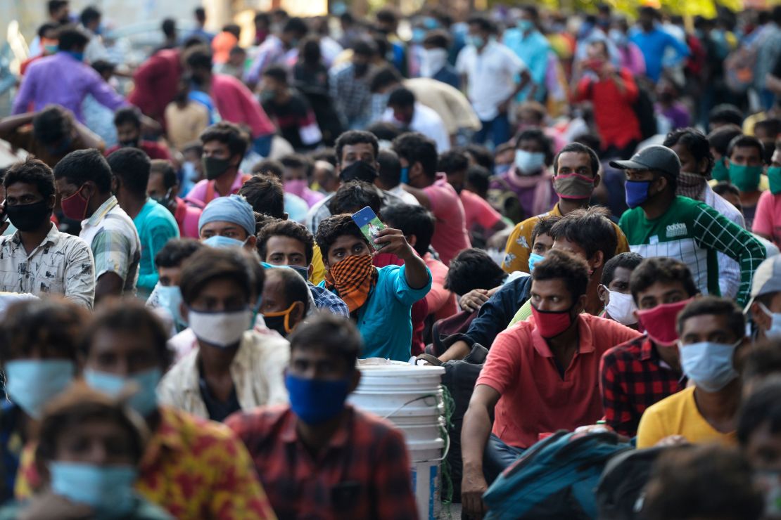 Stranded migrant labourers with their belonging wait to board a special train to Howrah station in Kolkata after the government eased a nationwide lockdown in Chennai on July 9, 2020. 