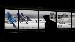A pilot walks by United Airlines planes as they sit parked at gates at San Francisco International Airport on April 12, 2020 in San Francisco, California. San Francisco International Airport has a seen a huge decline in daily flights since the coronavirus shelter in place. United Airlines, the airport's largest carrier with the most daily flights with 290 flights per day before the start of the COVID-19 pandemic, has reduced their daily flights to 50 per day. (Photo by Justin Sullivan/Getty Images)