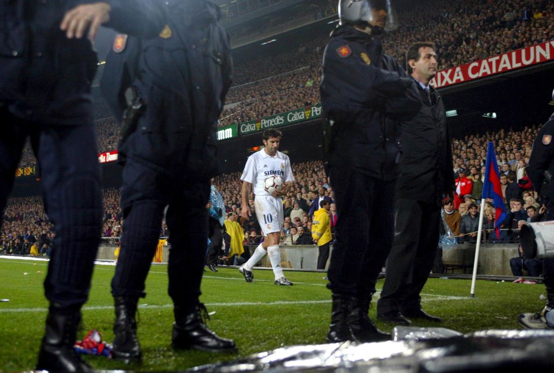 Luis Figo of Real Madrid prepares to take a corner with a police escort during the La Liga match between FC Barcelona and Real Madrid played at the Nou Camp Stadium, on November 23, 2002. 