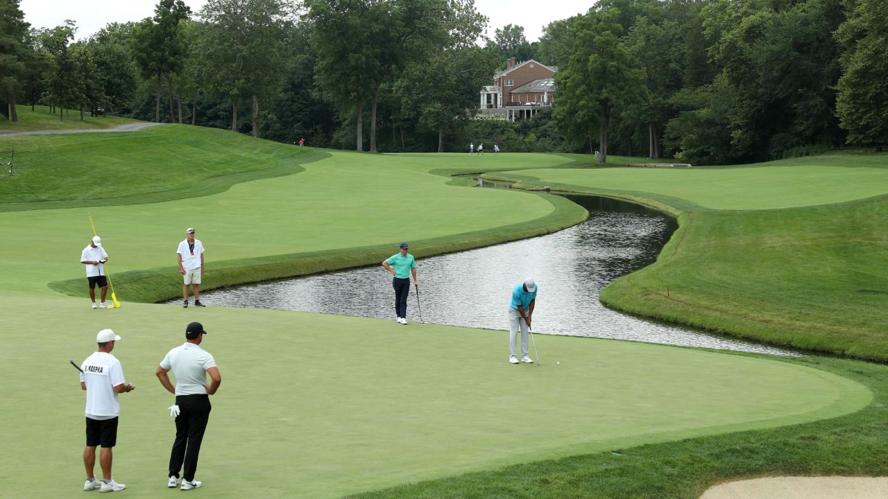 Woods putts on the fifth green as McIlroy (top) and Koepka (bottom) look on.